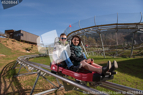 Image of couple enjoys driving on alpine coaster