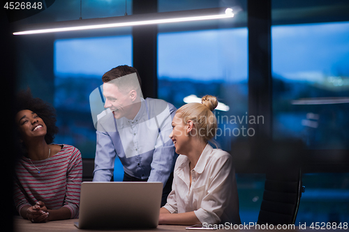 Image of Multiethnic startup business team in night office