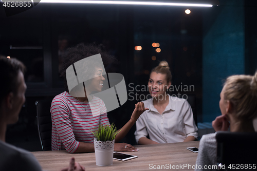 Image of Multiethnic startup business team in night office