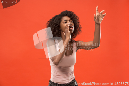 Image of Isolated on red young casual afro woman shouting at studio