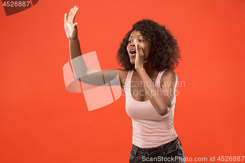 Image of Isolated on red young casual afro woman shouting at studio