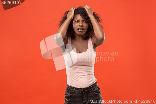 Image of Woman having headache. Isolated over red background.