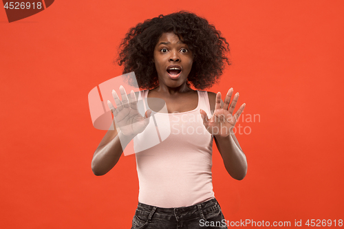 Image of Portrait of the scared woman on red