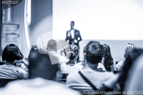 Image of Business speaker giving a talk at business conference event.