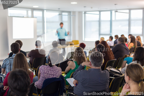 Image of Speaker giving presentation on business conference lecture.