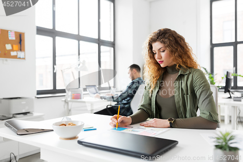 Image of creative woman working on user interface at office