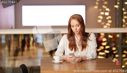 Image of woman with coffee and smartphone at restaurant