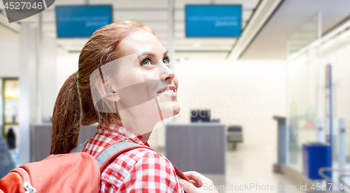 Image of young woman with backpack over airport terminal