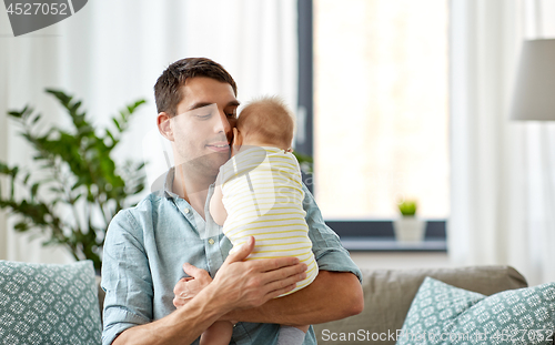 Image of father with little baby daughter at home