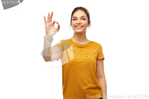 Image of happy smiling young woman showing ok hand sign
