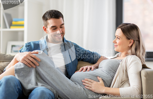 Image of happy man with pregnant woman at home