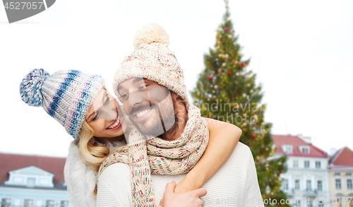 Image of happy couple hugging over christmas tree