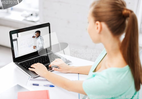 Image of student watching webinar on laptop at home office