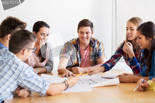 Image of group of smiling students with blueprint