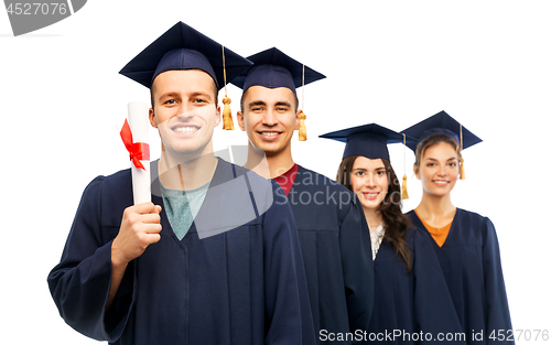 Image of graduates in mortar boards with diploma