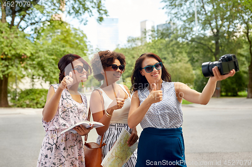 Image of women with map travelling and recording video blog