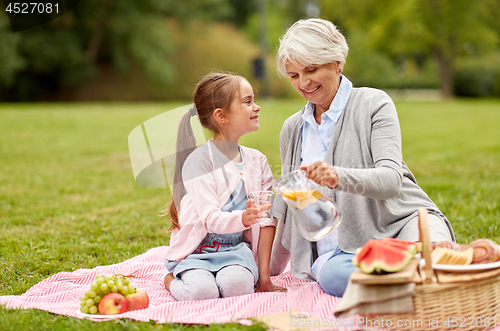 Image of grandmother and granddaughter at picnic in park