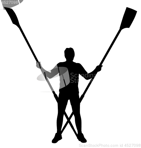 Image of Male rower standing with crossed rowing oars