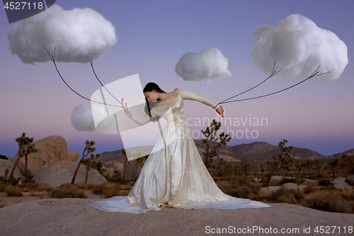 Image of Abstract Concept of Girl Attached to Clouds Representing Fantasy