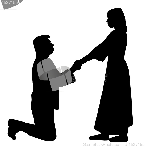 Image of Man on knees holding hands of woman and asking her to marry