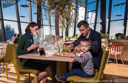 Image of happy family enjoying lunch time together