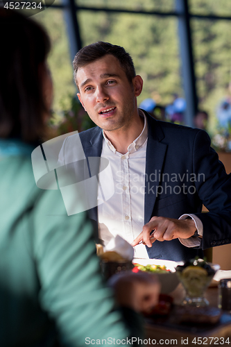 Image of youn couple enjoying lunch at restaurant