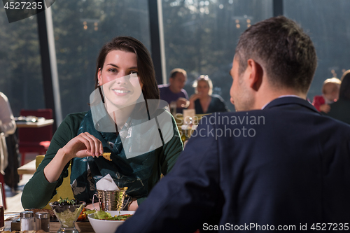 Image of youn couple enjoying lunch at restaurant