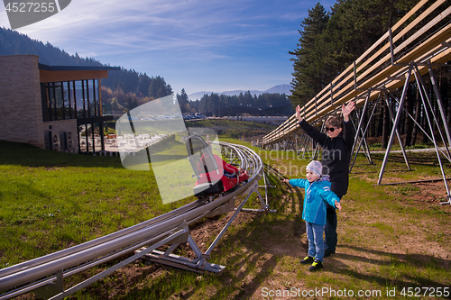 Image of Happy family enjoying alpine coaster