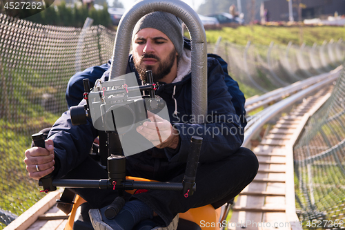 Image of videographer at work on alpine coaster