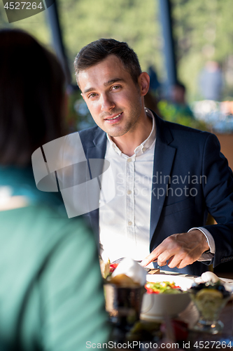Image of youn couple enjoying lunch at restaurant