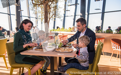 Image of happy family enjoying lunch time together