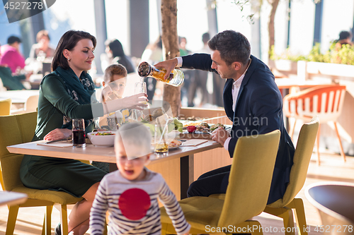 Image of happy family enjoying lunch time together