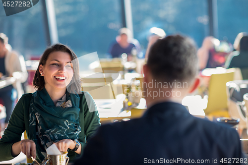 Image of youn couple enjoying lunch at restaurant