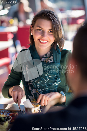 Image of youn couple enjoying lunch at restaurant