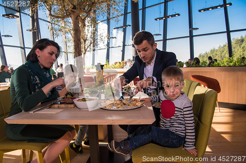 Image of happy family enjoying lunch time together