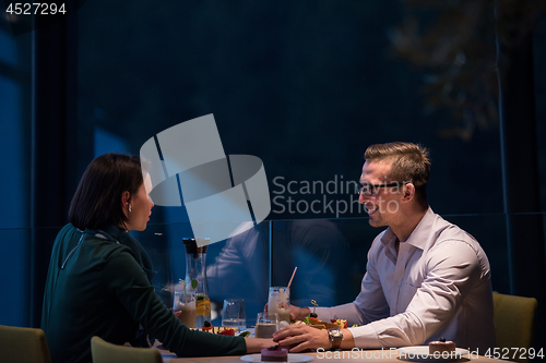 Image of loving couple enjoying romantic dinner