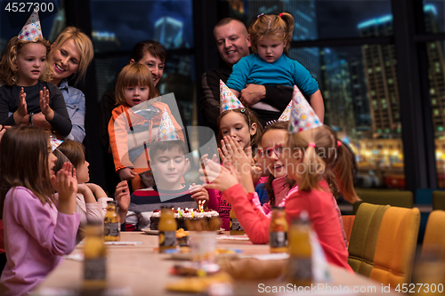 Image of happy young boy having birthday party