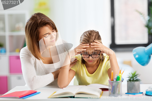 Image of mother helping daughter with difficult homework