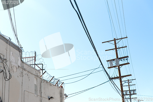 Image of transmission tower and power line over blue sky