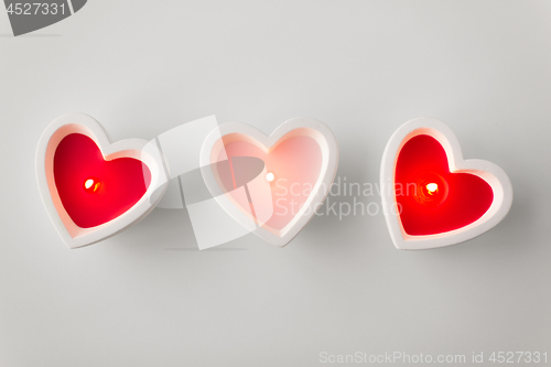 Image of heart shaped candles burning on valentines day