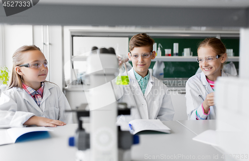 Image of kids with test tubes studying chemistry at school