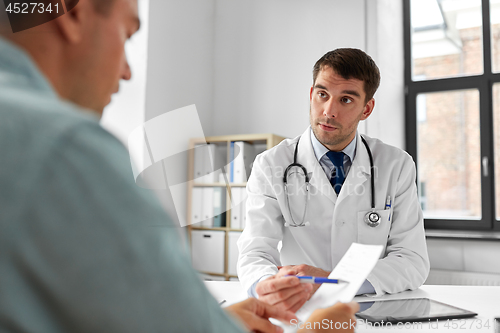 Image of doctor giving prescription to patient at hospital