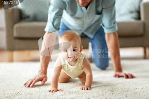 Image of happy little baby girl with father at home