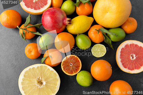 Image of close up of citrus fruits on stone table