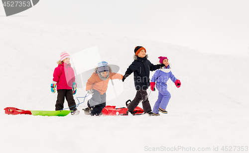 Image of happy little kids with sleds in winter