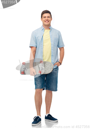 Image of smiling young man with skateboard over white