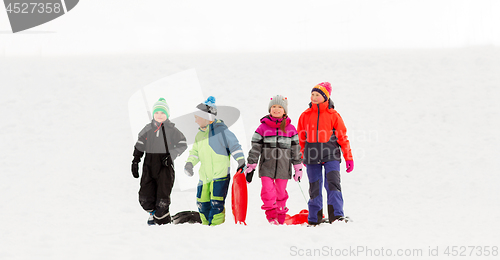 Image of happy little kids with sleds in winter