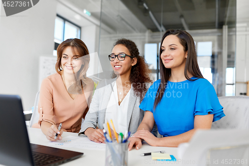 Image of businesswomen with laptop working at office