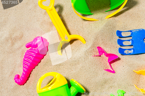 Image of close up of sand toys kit on summer beach