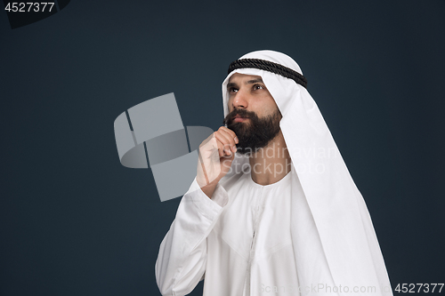 Image of Arabian saudi businessman on dark blue studio background